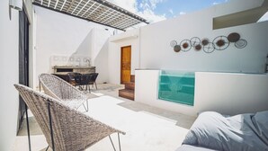 A modern outdoor living area with a pool, a dining set, and a seating area. - Selvatico PH and private pool by BT Homes (Tulum)