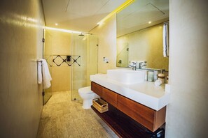A modern bathroom with a glass shower enclosure, a white sink, and a large mirror. - Selvatico PH and private pool by BT Homes (Tulum)