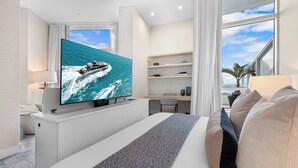 A modern hotel room with a large TV, a bed, a desk, and a view of the ocean. - Tresor 2-3702 (Miami Beach)