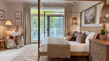 A bedroom with a four-poster bed, a wooden dresser, a large window with a view of trees, and a balcony.
