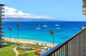 A beachfront hotel with multiple levels, a pool area, and a view of the ocean with sailboats. - 8th Floor 2BR Corner Suite with Oceanview Balcony (Lahaina)