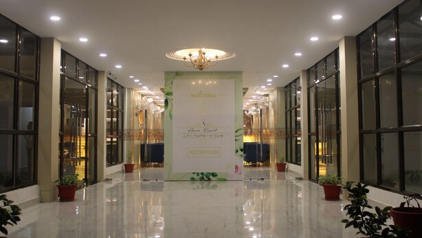 A reception area with a 'Welcome' sign, potted plants, and a chandelier. - Amar Resorrt Motihari Bihar (Motihari)