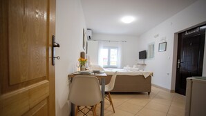 A room with a bed, a desk with a chair, a TV, and a window. - Lovely Studio Apartment 4 Vrsar, Vrsar, Croatia (Vrsar)