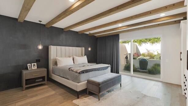 A bedroom with a bed, bedside table, and a view of the outdoors. - Private Mid-Century Oasis 3-bedroom home  in  Los Angeles with Pool/Spa & BBQ (Los Angeles)