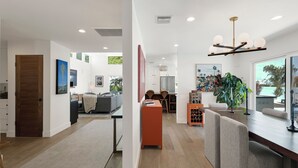 A modern interior with a dining area, kitchen, and living space. - Private Mid-Century Oasis 3-bedroom home  in  Los Angeles with Pool/Spa & BBQ (Los Angeles)