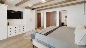 A bedroom with a bed, wardrobe, TV, and a mirror. - Private Mid-Century Oasis 3-bedroom home  in  Los Angeles with Pool/Spa & BBQ (Los Angeles)