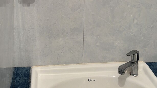 A bathroom with a mirror, a hand dryer, and a sink. - Sunrise View Farm-stay Narkanda (Kumharsain)