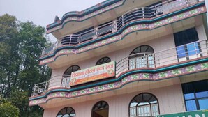 A multi-story building with balconies and a sign for 'Jiyana Hotel & Lodge.' - Jiyana Hotel and Lodge (Suryodaya)