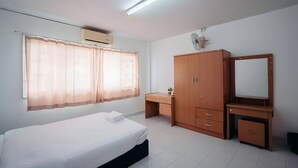 A bedroom with a bed, a desk, a wardrobe, and a mirror. - Oh My Nap Bangsaen (Chonburi)