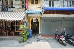 A storefront with a sign reading 'Bob House,' a motorcycle parked in front, and a potted plant beside the entrance. - AT Pranakorn (Bangkok)