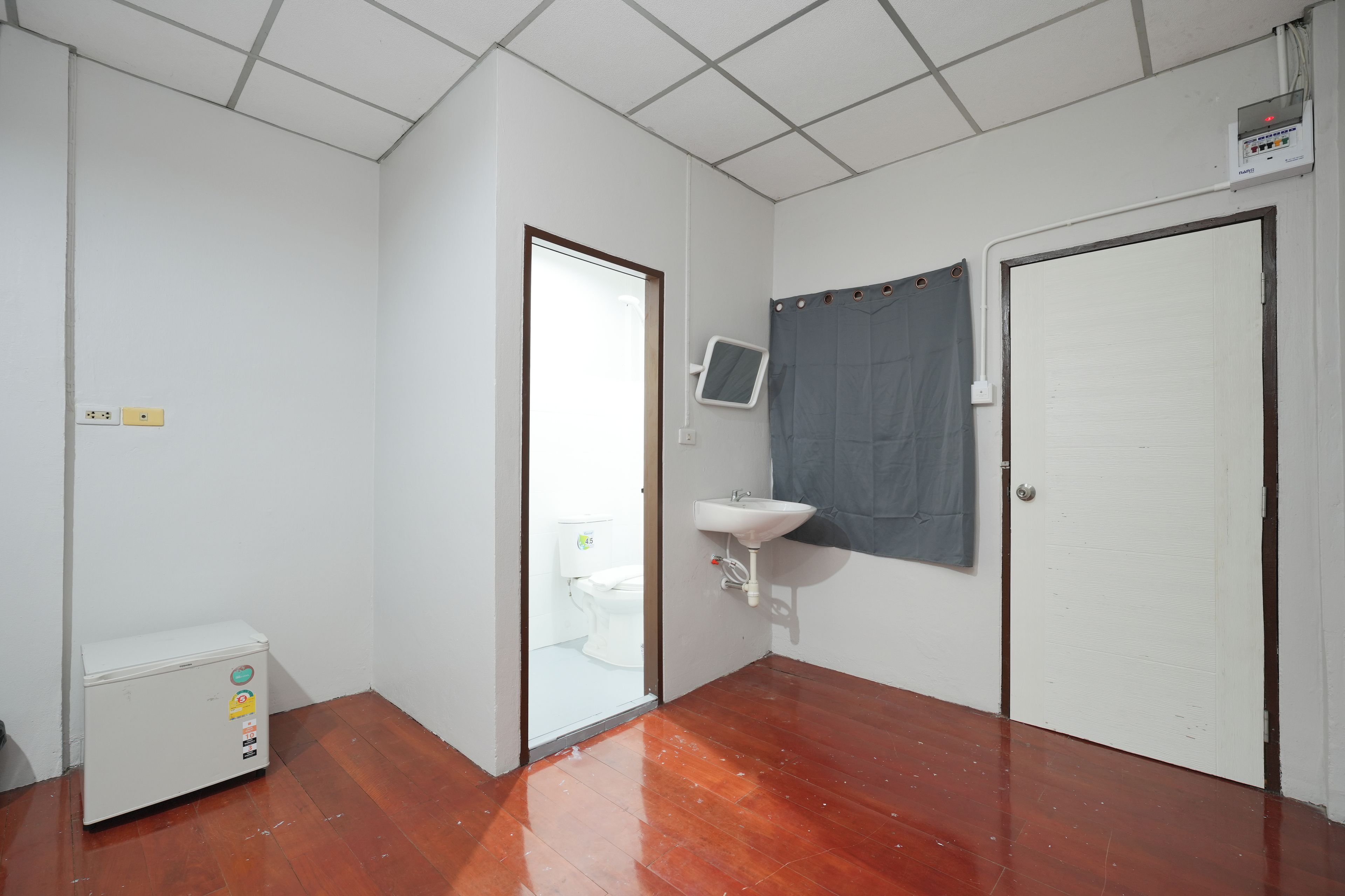 A small, clean room with a toilet, a sink, and a shower curtain.