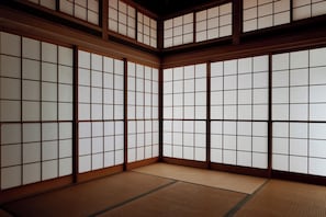 A traditional Japanese room with tatami flooring and shoji screens.