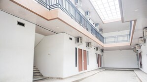 A multi-level interior with a staircase, a balcony, and a skylight.