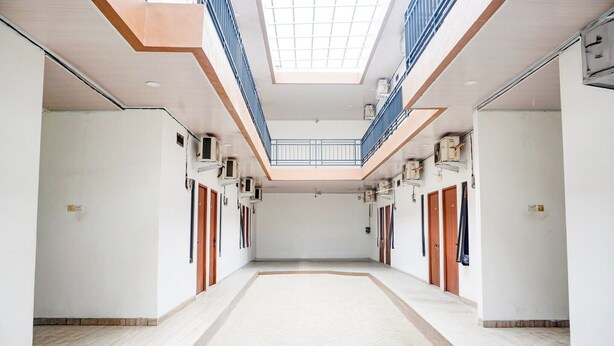 A spacious interior with a central open area, a skylight, and a mezzanine level.