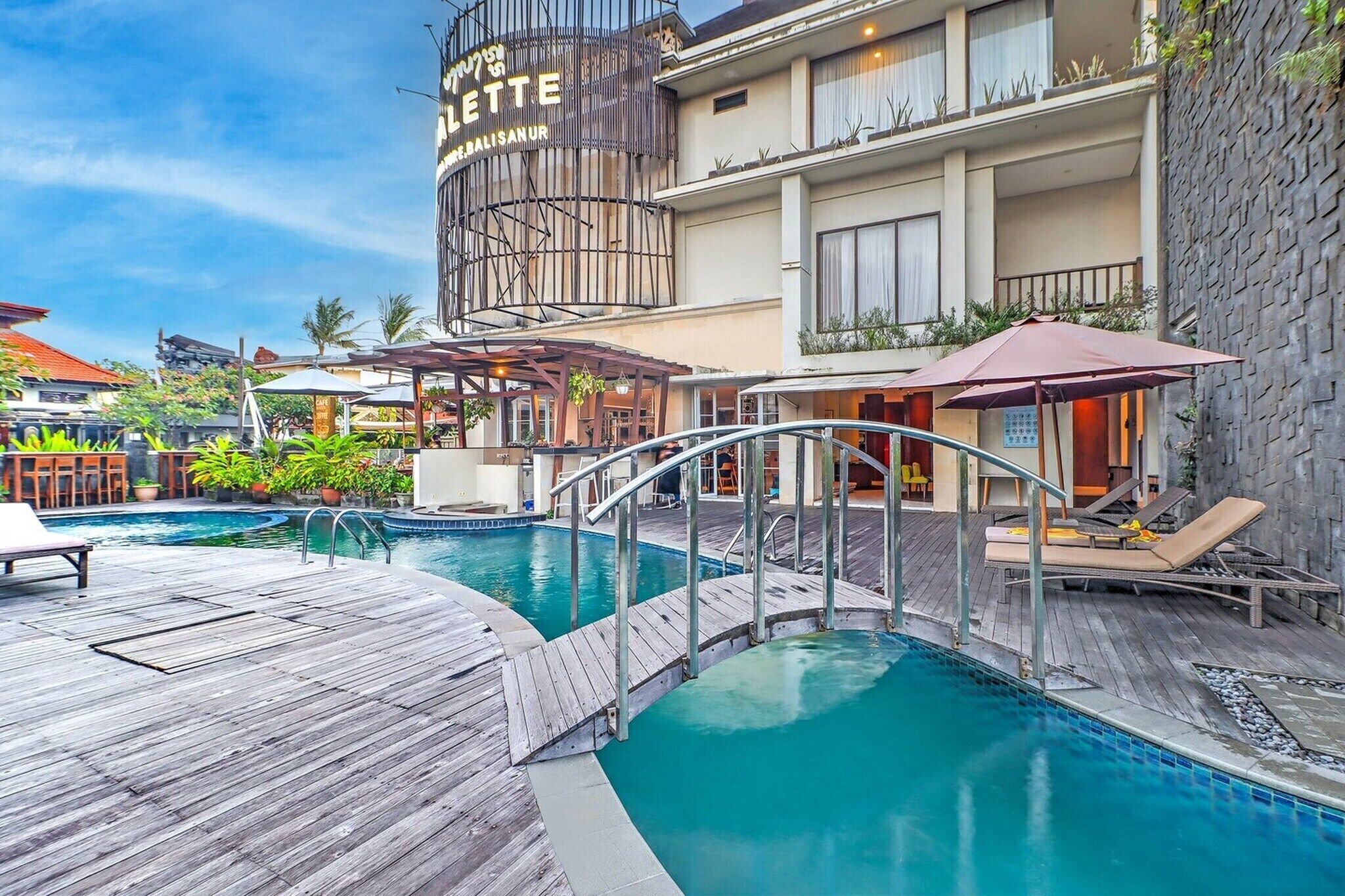 Un hôtel doté d’une piscine, d’un espace extérieur aménagé et d’une terrasse couverte.