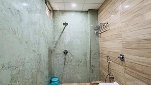 A bathroom with a shower, a sink, and a toilet. - Hotel Krishna Continental  (Prayagraj)