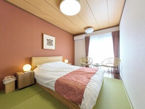 A hotel room with a bed, bedside lamps, a wall-mounted air conditioner, a window with curtains, and a chair by the window. - Wabi-Sabi Garden Stay TOKYO HANEDA (Tokyo)