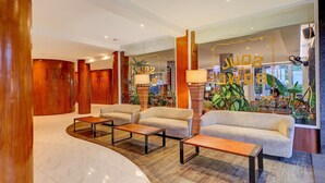 A lobby with sofas, tables, and a large window with plants. - Luxury Two Bedroom Villa with Pool and WiFi Access (Bali)