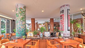 A hotel lobby with wooden furniture, a reception desk, and decorative pillars. - Luxury Two Bedroom Villa with Pool and WiFi Access (Bali)