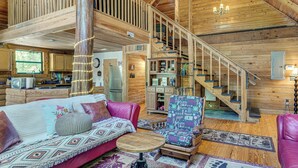 A log cabin interior with a loft bedroom, a dining area, and a kitchen. - Fish & Float at Natural Springs! Log Cabin in Bell (Bell)