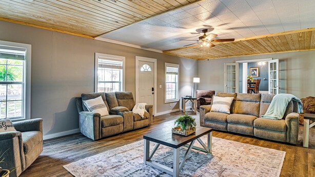 A spacious living room with two sofas, a coffee table, and a ceiling fan. - Surrounding Pasture Views! Peaceful Escape in Iuka (Iuka)