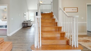 A staircase with white railings and wooden steps leading to a second floor. - Private Yard & Pool Access! Family Home in Acworth (Acworth)