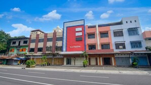 A multi-story building with a prominent red and white sign reading 'VIJI FOODIE'. - Spacious Double Suite Haven w/ Free Parking & WiFi (Makassar)