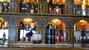 A bar area with a bottle of K5 Whisky and a glass of whiskey. - Tendrel Resort (Trongsa)