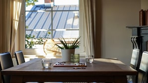 A dining table with chairs, a potted plant, and two glasses. - Villa with swimming pool near Durbuy (Barvaux)