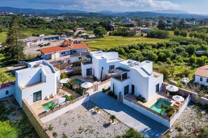 A modern two-story house with a swimming pool, surrounded by greenery and a clear view of the landscape. - Gemini Villas - Elysium (Rhodes)
