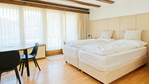 Un dormitorio con cama, escritorio y silla.