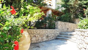 A stone staircase leading to a building with a stone wall and greenery around. - Porto Cheli 4Bedroom Villa Plunge Pool & SeaView 2 (Kosta)