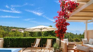 A terrace with a pool, lounge chairs, a sofa, and a pergola with flowers. - Porto Cheli 4Bedroom Villa Plunge Pool & SeaView 2 (Kosta)