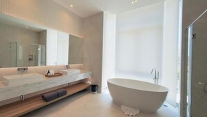 A modern bathroom with a freestanding bathtub, a large mirror, and a shower enclosure. - Phuvista Villas Naithon - Escape Villas  (Sa Khu)