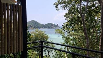 A hot tub with a view of a coastal landscape.