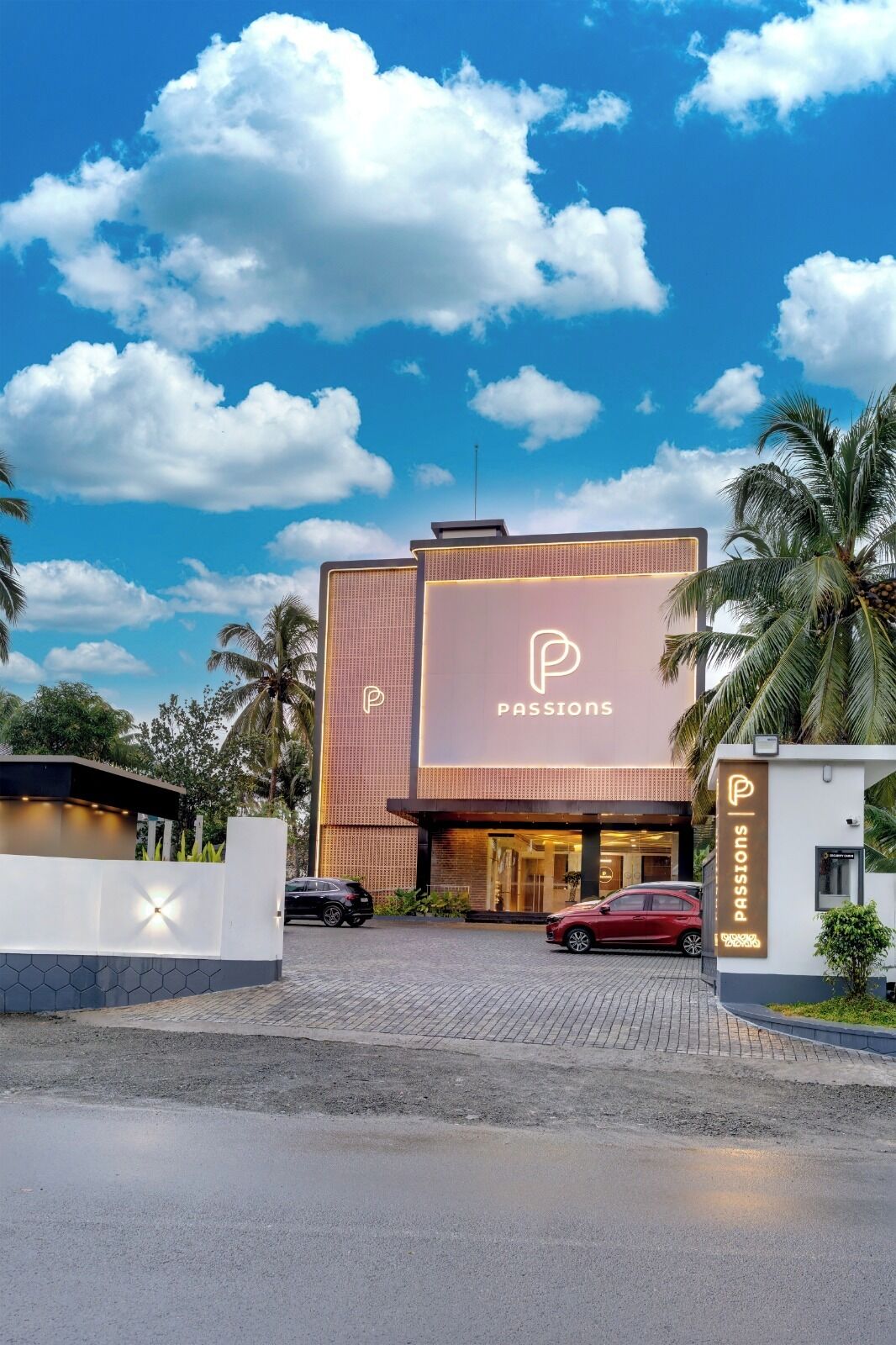 A modern building with a prominent 'Passions' sign, a gated entrance, and a parking area.