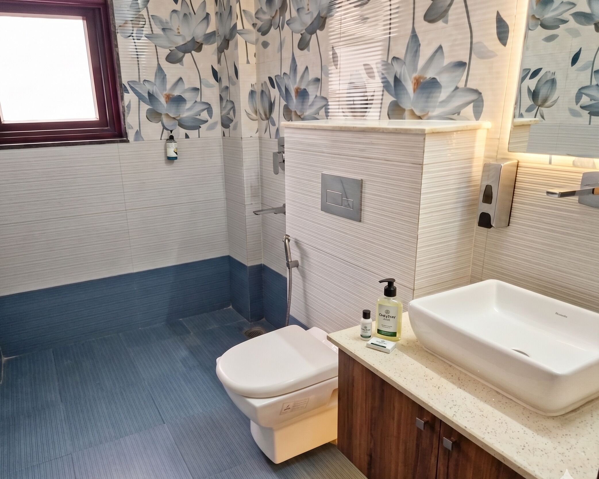 A bathroom with a toilet, sink, and shower.