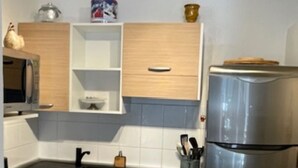 A modern kitchen with a dishwasher, microwave, and a stainless steel refrigerator. - VALBERG TOWN CENTRE - 3 rooms (50m2) 2 bedrooms + 36m2 terrace (VALBERG)