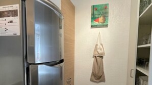 A compact kitchen with a stainless steel refrigerator, a small trash bin, and a wall-mounted towel. - VALBERG TOWN CENTRE - 3 rooms (50m2) 2 bedrooms + 36m2 terrace (VALBERG)