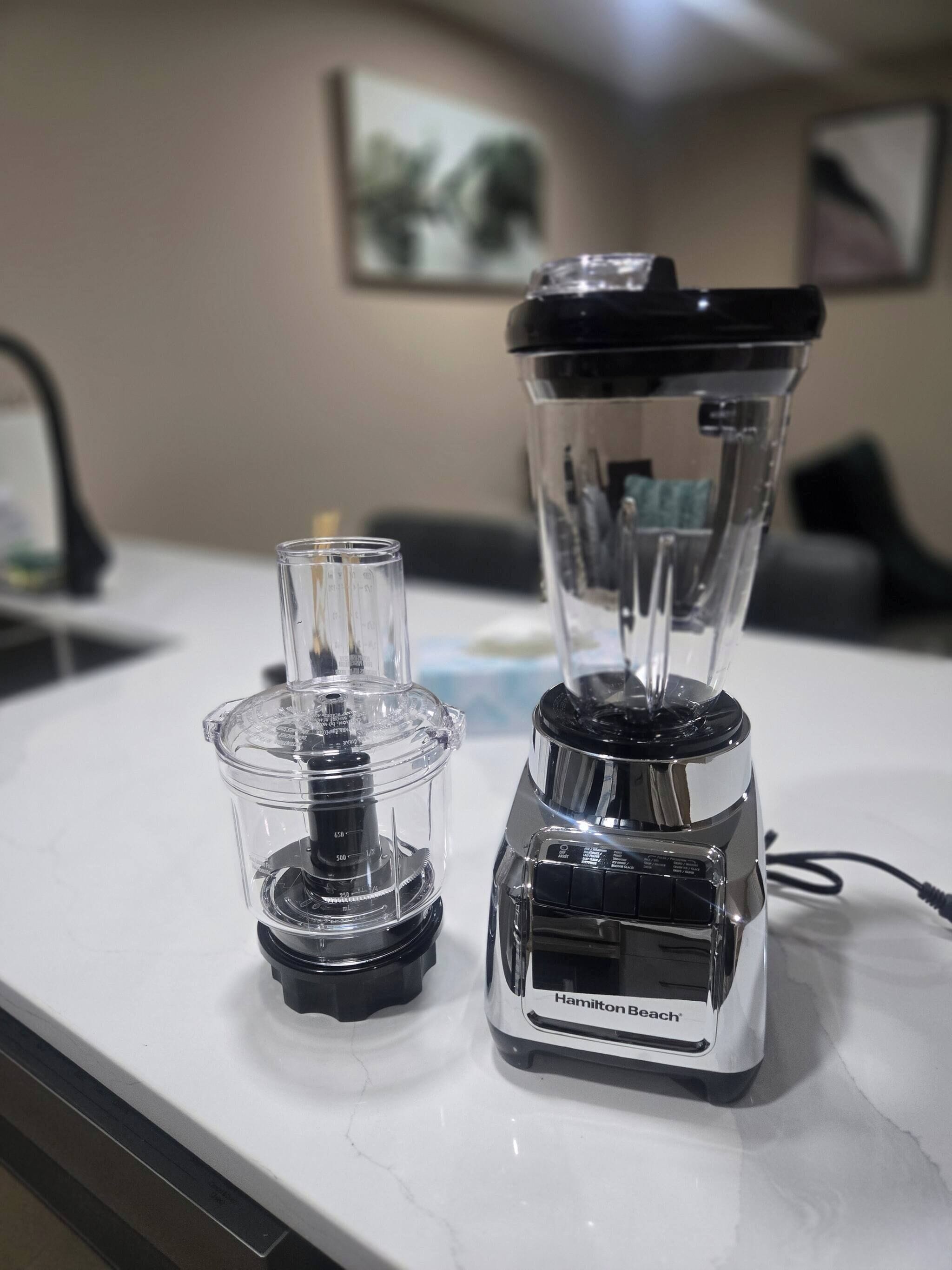 A kitchen counter with a Hamilton Beach blender and a smaller container.
