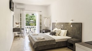 A bedroom with a bed, bedside tables, a desk, and a chair. - Ionian Blue Beach - Adults Only (Corfu)