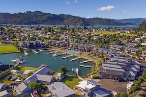 A marina with boats docked, surrounded by residential buildings and greenery.