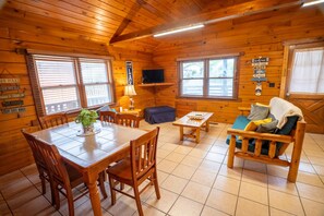Fireplace - Sunrise Cove Log Cabin - Sunrise Cove is your perfect family escape on Lake Barkley! This charming log cabin offers two bedrooms, a sleeping loft, full kitchen, and bathroom with shower. (Eddyville)