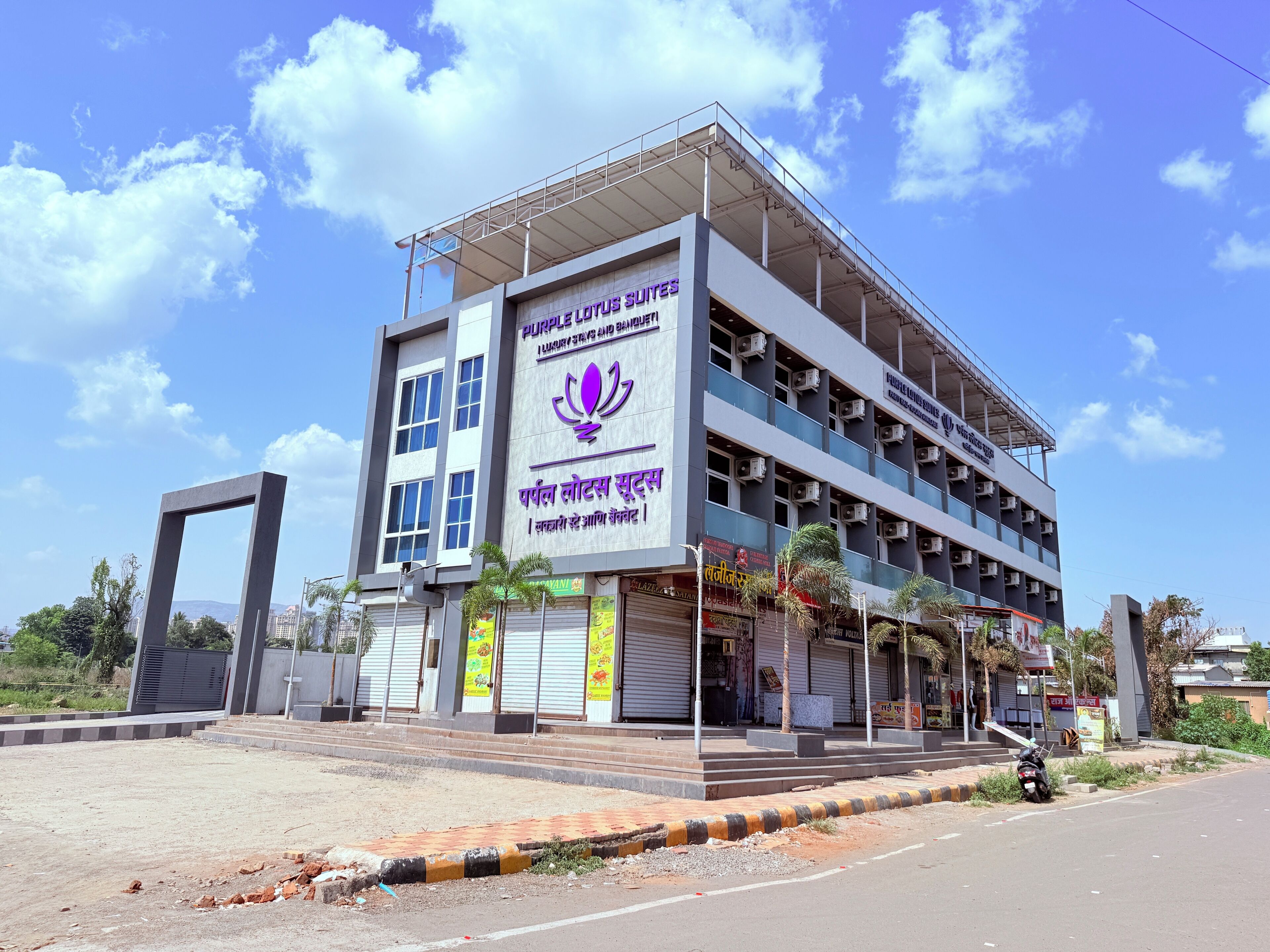 A multi-story building with a prominent sign for 'Purple Lotus Suites.'