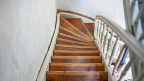 A wooden staircase with white railings.