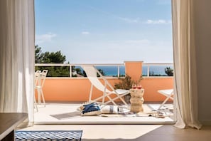 A balcony with a view of the sea, white chairs, a table, and a small plant. - Refugi Blau, sea view in Son Bou (Son Bou)