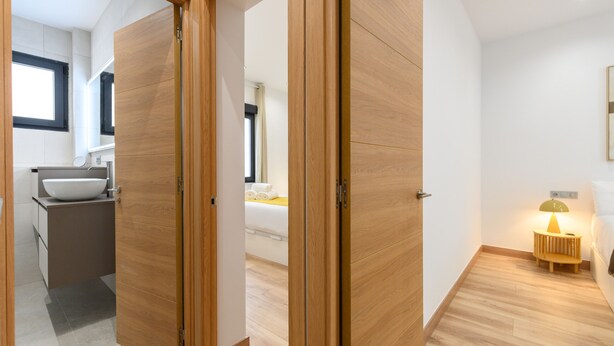 A modern bathroom with a sink, mirror, and wooden flooring. - (DDS1014) 2 bedroom apartment in Goya, Salamanca District (Madrid)