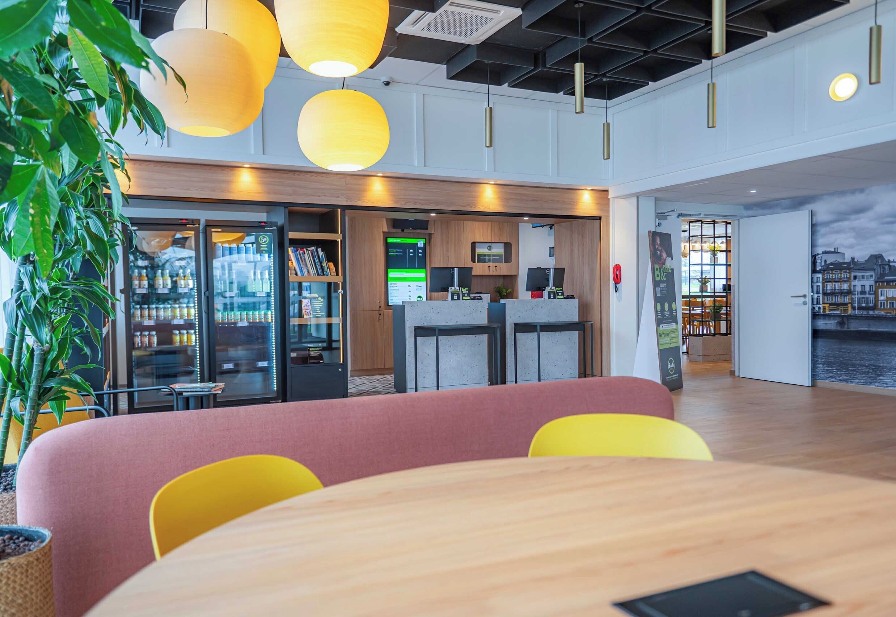 A modern interior with seating, a reception area, and a view of the city.