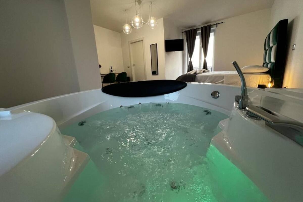 A modern bathroom with a large bathtub, a shower area, and a mirror.