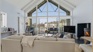 Sink into the generous corner sofa, light the woodburning stove, and enjoy a relaxed evening with family or friends. - Little Acorns - A Lakeside Retreat in Somerford Keynes, Sleeps 4. (Cirencester)
